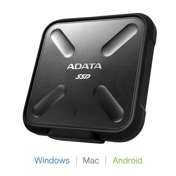 A hand gripping a small black box labeled "ADATA," showcasing the brand's logo prominently on the surface.